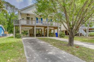 a house with a porch and a driveway at Charming Oak Island Home 1 Mi to Beach! in Oak Island