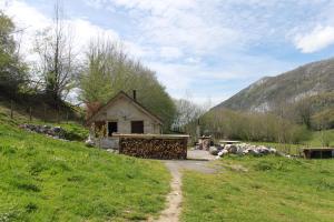 una pequeña casa en un campo con un camino de tierra en Cabanots - Ecolodges en Vallée d'Ossau à 900m d'altitude, 