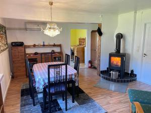 a dining room with a table and a wood stove at Holiday Home Bengtsfors in Bengtsfors