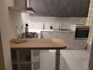 a kitchen with a wooden table in the middle at La finestra sul corso in Ortona