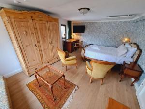 a bedroom with a bed and a table and chairs at Haus Moselwald - 3 bedrooms in Enkirch