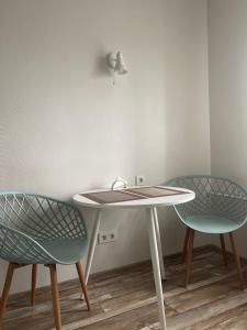a table with two chairs and a sink at Apartment for a pleasant stay in Odesa