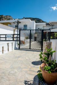 a patio with a black gate and some plants at Μοντέρνο διαμέρισμα ALMYRA in Agios Nikolaos