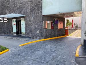 a gas station with a yellow line in front of it at HOTEL M ELITE ROJO in Mexico City