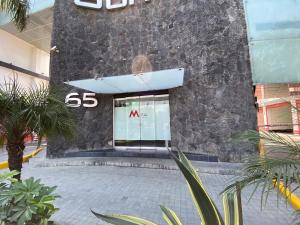 a building with a sign in front of it at HOTEL M ELITE ROJO in Mexico City