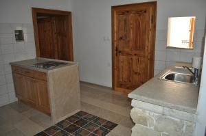 a kitchen with a sink and a counter top at Apartments Koptur in Škocjan