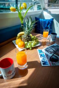 a wooden table with oranges and fruit on it at Private boat with skiper in Prijevor