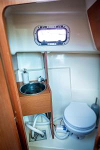 a bathroom with a sink and a toilet in an rv at Private boat with skiper in Prijevor