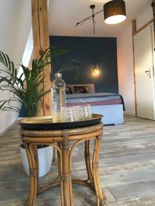 a wooden table with glasses on it with a bed at Red Chapel in Łagów