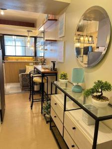 a kitchen with a table and a mirror on the wall at AVIDA ATRIA Tower 3 in Iloilo City