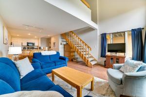 a living room with blue chairs and a blue couch at Trout Creek Resort Condo - 1 Mi to Nubs Nob! in Harbor Springs