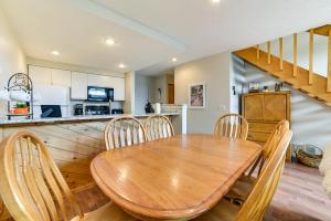 a dining room and kitchen with a wooden table and chairs at Trout Creek Resort Condo - 1 Mi to Nubs Nob! in Harbor Springs
