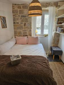 een slaapkamer met een groot bed en een stenen muur bij Our Best Chapter in Split