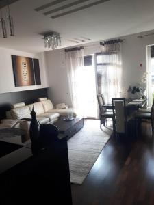 a living room with a white couch and a table at Apartament nad jeziorem w Brodnicy in Brodnica