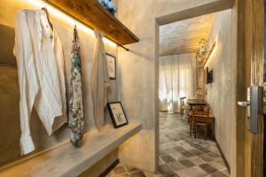 a hallway with a door leading to a dining room at Via Roma Charming Rooms in Baunei