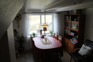 a dining room with a table and a window at Cottage in Saksun in Saksun