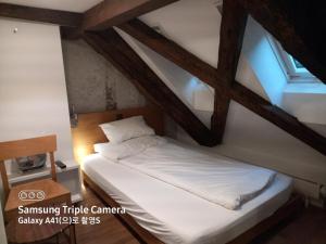 a bed in a room with a ceiling at Hotel Lestelle - self check-in in Lucerne