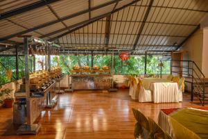 a large room with tables and chairs in it at Belljem Homes -your own private resort -5 BHK in Trichūr