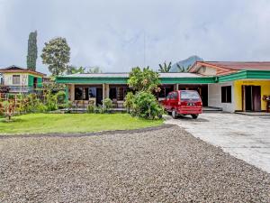 a red van parked in front of a house at OYO 92534 Fajar Indah Guest House in Karanganyar