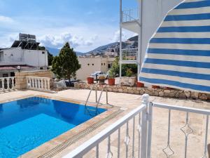 a view from the balcony of a house with a swimming pool at Kalkan Centre Bijou Home - Walk to town and beach in Kalkan