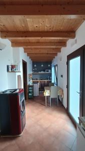 a kitchen and living room with a table and a stove at B&B Kikina in Austis