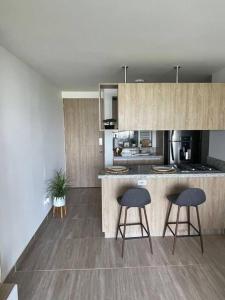 a kitchen with two stools and a counter top at New, cozy & stylish apartment in Armenia