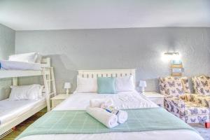 a bedroom with a bed and two bunk beds at San Lameer Villa 2513 by Top Destinations Rentals in Southbroom