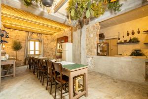 a kitchen with a long table and chairs at Via Roma Charming Rooms in Baunei
