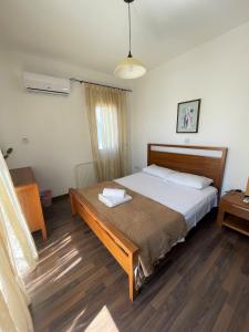 a bedroom with a bed and a wooden floor at Casa Pernera in Protaras