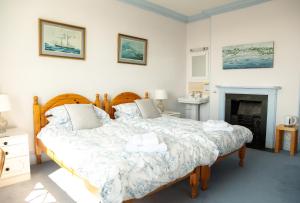 a bedroom with a bed and a fireplace at Ivy House Cornwall B&B in St Austell