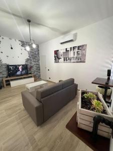 a living room with a couch and a tv at Cinque Terre HUB LUXURY HOME IN LA SPEZIA in La Spezia