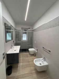 a large bathroom with two sinks and a toilet at Cinque Terre HUB LUXURY HOME IN LA SPEZIA in La Spezia