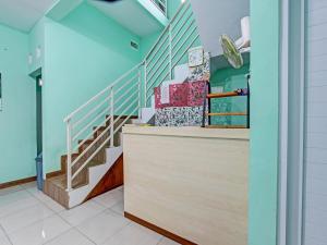 a staircase in a building with blue walls at OYO 92521 Guest House Inayah Syariah in Yogyakarta