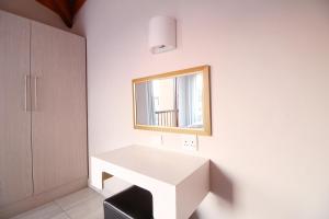 a white desk in a room with a mirror at San Lameer Villa 1931 by Top Destinations Rentals in Southbroom