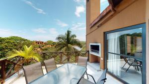 a balcony with a table and chairs and a view at San Lameer Villa 1931 by Top Destinations Rentals in Southbroom