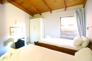 a bedroom with two beds and a window at San Lameer Villa 1931 by Top Destinations Rentals in Southbroom