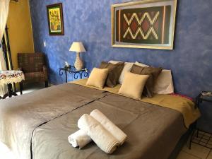 a bedroom with a large bed with towels on it at Suite Antequera en mexico in Oaxaca City