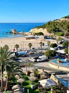 a view of a beach with a parking lot and the ocean at ALCOTAN 2 Modern apartment with sea view & big sunny terrace in Cala de Finestrat