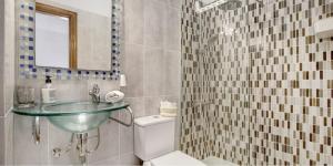 a bathroom with a glass sink and a toilet at Residencial Maresia el Medano in El Médano +19 photos
