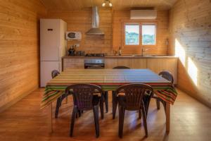 a kitchen with a table and chairs and a refrigerator at Villa Vilosa - Anna in Anna