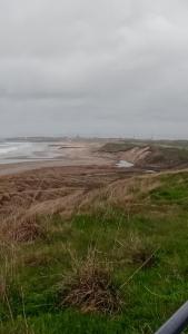 a view of a beach with the ocean and grass at Crimdon dene bay view holiday home NO SMOKING NO PETS in Durham