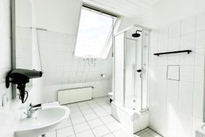 a white bathroom with a sink and a shower at Maisonette Apartment in Krefeld mit 2 Balkone in Krefeld +13 photos