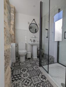 a bathroom with a toilet and a sink and a shower at La Suite Gignac in Gignac
