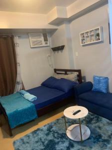 a bedroom with a bed and a couch and a table at Condo in Avida tower IT park , Lahug Cebu city, Fully furnished in Cebu City +11 photos