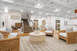 a lobby with chairs and a table and stairs at Nantucket Inn in Nantucket