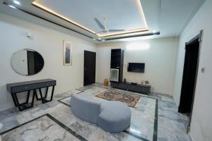 a living room with a couch and a mirror at SK Residence in Islamabad
