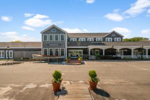 a large building with a boat in a parking lot at Nantucket Inn in Nantucket