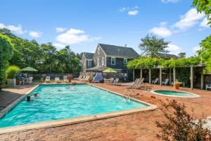 a swimming pool in front of a house at Nantucket Inn in Nantucket