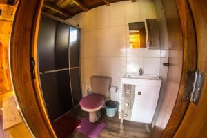 a small bathroom with a shower and a toilet at Chalés Vista Bonita in Urubici