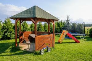a gazebo with a slide and a playground at O.S.W. WICIE in Wicie